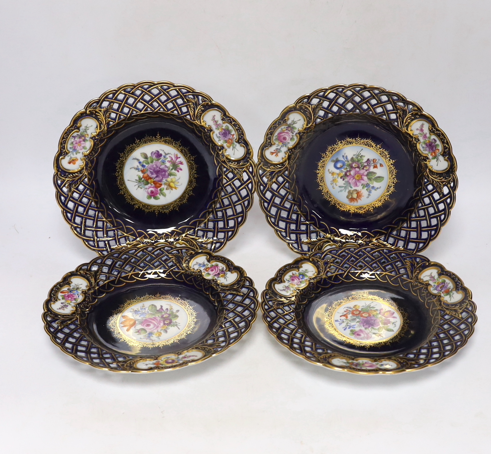 A set of four Dresden blue porcelain cabinet plates decorated with flowers, 21cm